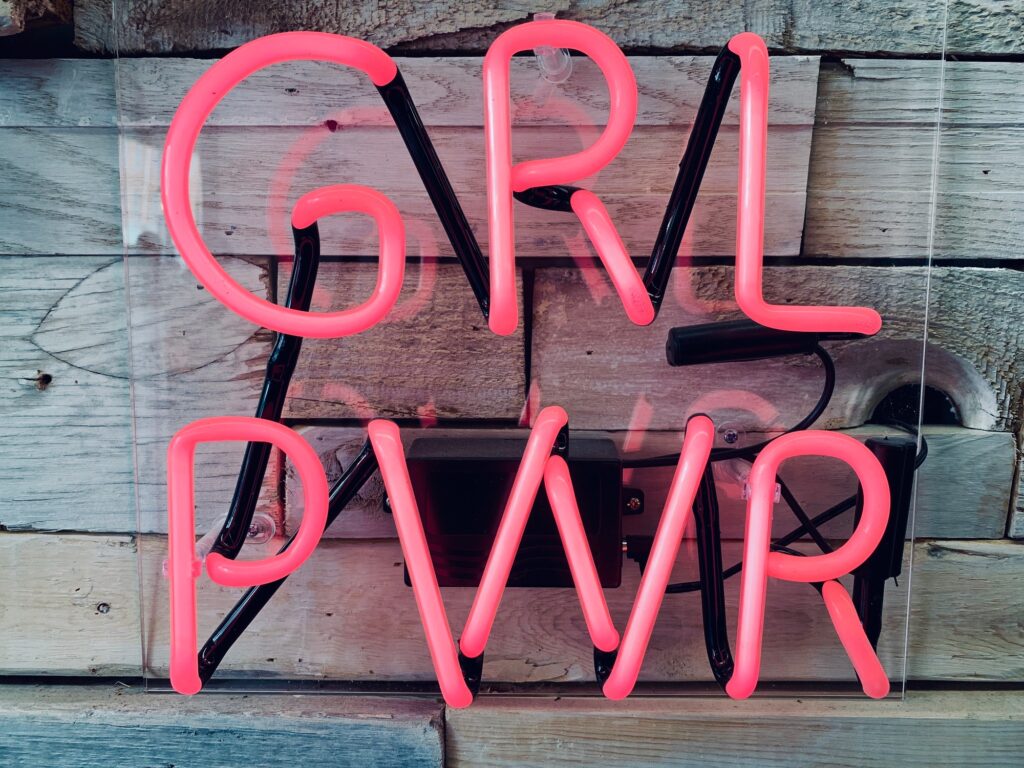 Girl power sign in neon pink that empowers women and young girls