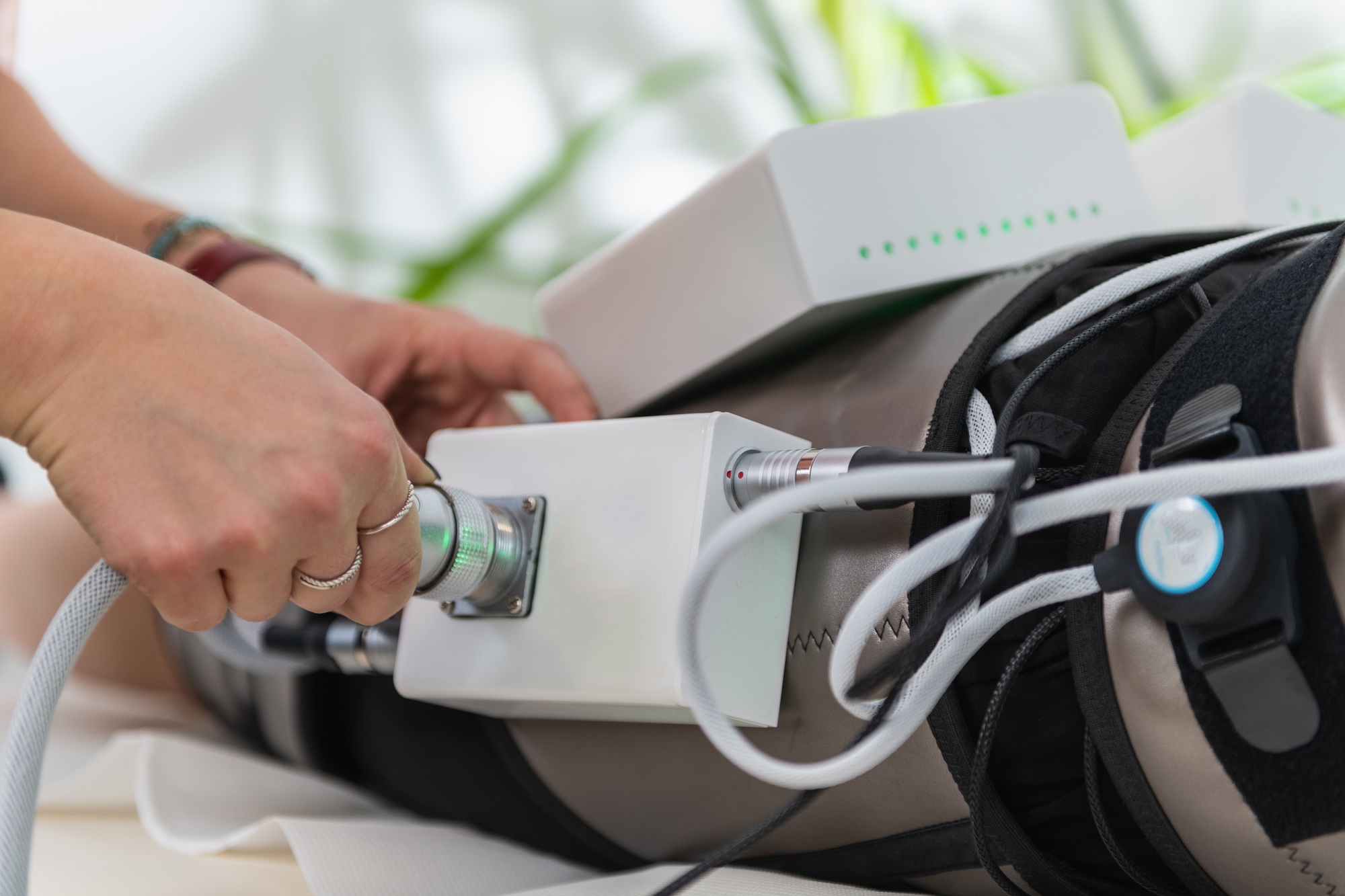 Salon Therapist Powers Electric Muscle Stimulator for Weight Loss